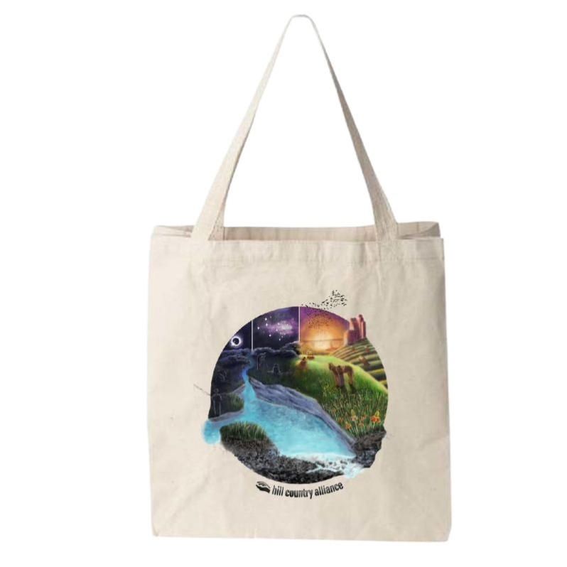 Product Description: Hill Country Scene Tote Bag</br></br>This limited edition, tan-colored tote bag design shows a beautiful view of the Hill Country - a bright river flows next to people and wildlife. The closer you look the more you see! Two design options are available: one in color and one in black and white.</br></br>Please allowat least 1 weekfor delivery!</br></br>About the Design</br></br>The Hill Country Alliance is proud to announce the release of a limited edition Hill Country creation, designed by 2023 Kent Butler Summer Intern Emma Margulies. Emma is currently pursuing a Masters in Landscape Architectureat the University of Texas in Austin. Here's a bit more about Emma and her art in her own words:</br></br>As an intern at HCA during the summer of 2023, I had the opportunity to speak with partners across the Hill Country about how development is affecting their communities and what can be done about it. The beauty of the Hill Country helped lure me to graduate school in Austin, and it was such a pleasure to see it through the eyes of people who have lived here and loved this place much longer than I have...</br></br>Natural infrastructure, like pristine streams and open spaces, enriches and protects our quality of life, while rooted plants and karst geology connect the surface to the earth below, the mostly invisible world of soils and aquifers that are responsible for the wildflower blooms and crystal-clear springs that make many (myself included) fall in love with this place. The joy of these natural treasures brings people together across generations, bonding them to each other and this place and giving them a reason to protect it.</br></br>You can learn more about Emma and her work with HCA onour website.All proceeds from the sale of this limited release printing will benefit the Hill Country Alliance.</br> Hill Country Scene Tote Bag
