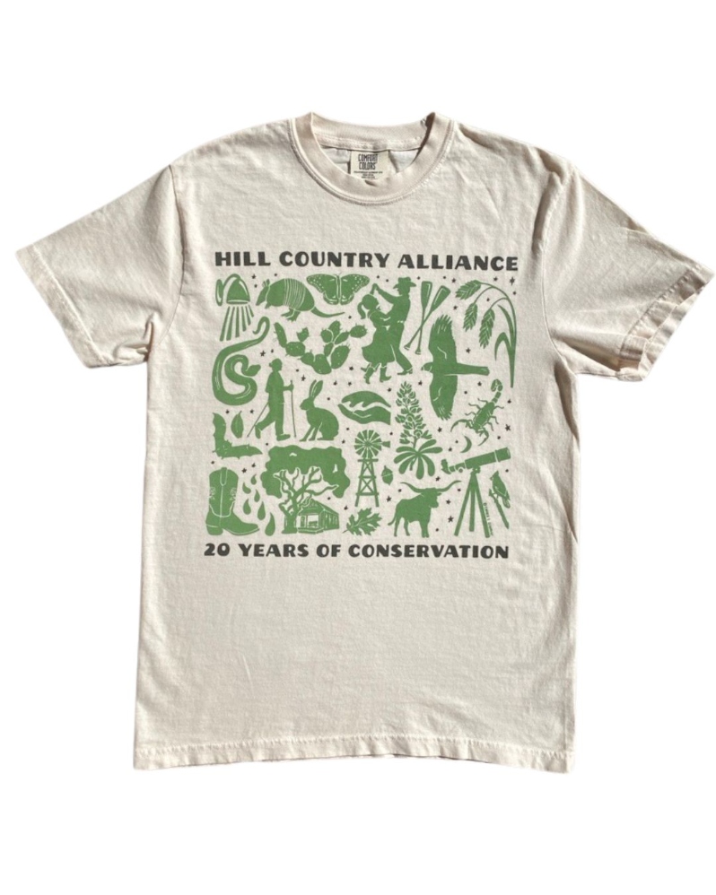 Product Description: Celebrate HCA's 20th Anniversary with us!</br></br>Mark the occasion with a limited-edition Comfort Colors T-shirt in cream, featuring silhouettes of iconic Hill Country landscapes and symbols.Available in unisex sizes S–2XL. Quantities are limited—so don’t wait too long!</br></br>Please allow at least 1 week for delivery!</br></br>About the Design</br></br>The Hill Country Alliance is proud to announce the release of a limited-edition Hill Country creation, designed by local artist Emma C. Schmidt. Native to the Texas Hill Country, Emma draws inspiration from the natural world around her to create hand drawn designs that tell meaningful stories. With a background in painting from Savannah College of Art & Design, she has grown her art practice through a range of mediums, including intricate inked maps, watercolors, illustration and large-scale painted murals. She uses her artwork to tell stories and chart memories. In recent years, her artwork has taken a nature focus with a range of subjects from bird migration flyways, state aquifers and springs, hiking trail maps and native species illustrations. Emma approaches her work as a cartographer, naturalist and storyteller to create artwork that uplifts a landscape in hand drawn inked lines.Learn more about Emma’ work on her website here.</br></br>For this 20-year anniversary artwork, Emma found inspiration in HCA’s four programs: land, water, night skies and community. With familiar silhouettes of iconic Hill Country indicators in natural landscape and how Texans interact with it, Emma’s artwork shares an encompassing view of one of our state’s treasured geographic regions and a vision to conserve and pay homage to its singularity. </br></br>Printed with Care</br></br>Screen printingby Raw Paw in South Austin. Proceeds from this limited release support the Hill Country Alliance and our mission to protect the region we call home.</br> 20th Anniversary T-Shirt