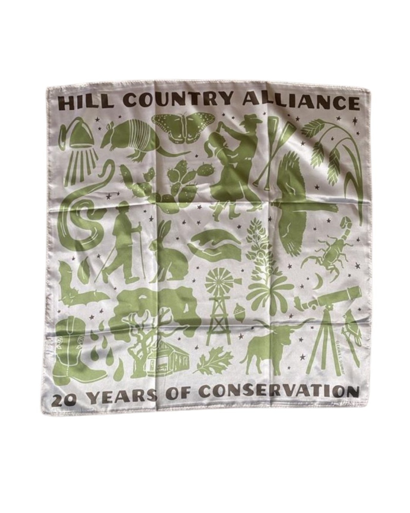 Product Description: Celebrate HCA's 20th Anniversary with us!</br></br>Commemorate this milestone with our first-ever limited-edition satin bandana release! Printed on cream satin fabric and designed with silhouettes of iconic Hill Country landscapes and symbols, this versatile piece can be worn, carried, or kept as a keepsake. Quantities are limited—so don’t wait too long.</br></br>Bandana dimensions: 22 x 22 inches</br></br>Please allowat least 1 weekfor delivery!</br></br>About the Design</br></br>The Hill Country Alliance is proud to announce the release of a limited-edition Hill Country creation, designed by local artist Emma C. Schmidt. Native to the Texas Hill Country, Emma draws inspiration from the natural world around her to create hand drawn designs that tell meaningful stories. With a background in painting from Savannah College of Art & Design, she has grown her art practice through a range of mediums, including intricate inked maps, watercolors, illustration and large-scale painted murals. She uses her artwork to tell stories and chart memories. In recent years, her artwork has taken a nature focus with a range of subjects from bird migration flyways, state aquifers and springs, hiking trail maps and native species illustrations. Emma approaches her work as a cartographer, naturalist and storyteller to create artwork that uplifts a landscape in hand drawn inked lines.Learn more about Emma’ work on her websitehere.</br></br>For this 20-year anniversary artwork, Emma found inspiration in HCA’s four programs: land, water, night skies and community. With familiar silhouettes of iconic Hill Country indicators in natural landscape and how Texans interact with it, Emma’s artwork shares an encompassing view of one of our state’s treasured geographic regions and a vision to conserve and pay homage to its singularity. </br></br>Printed with Care</br></br>Screen printingbyCC Creations. Proceeds from this limited release support the Hill Country Alliance and our mission to protect the region we call home.</br> 20th Anniversary Satin Bandana